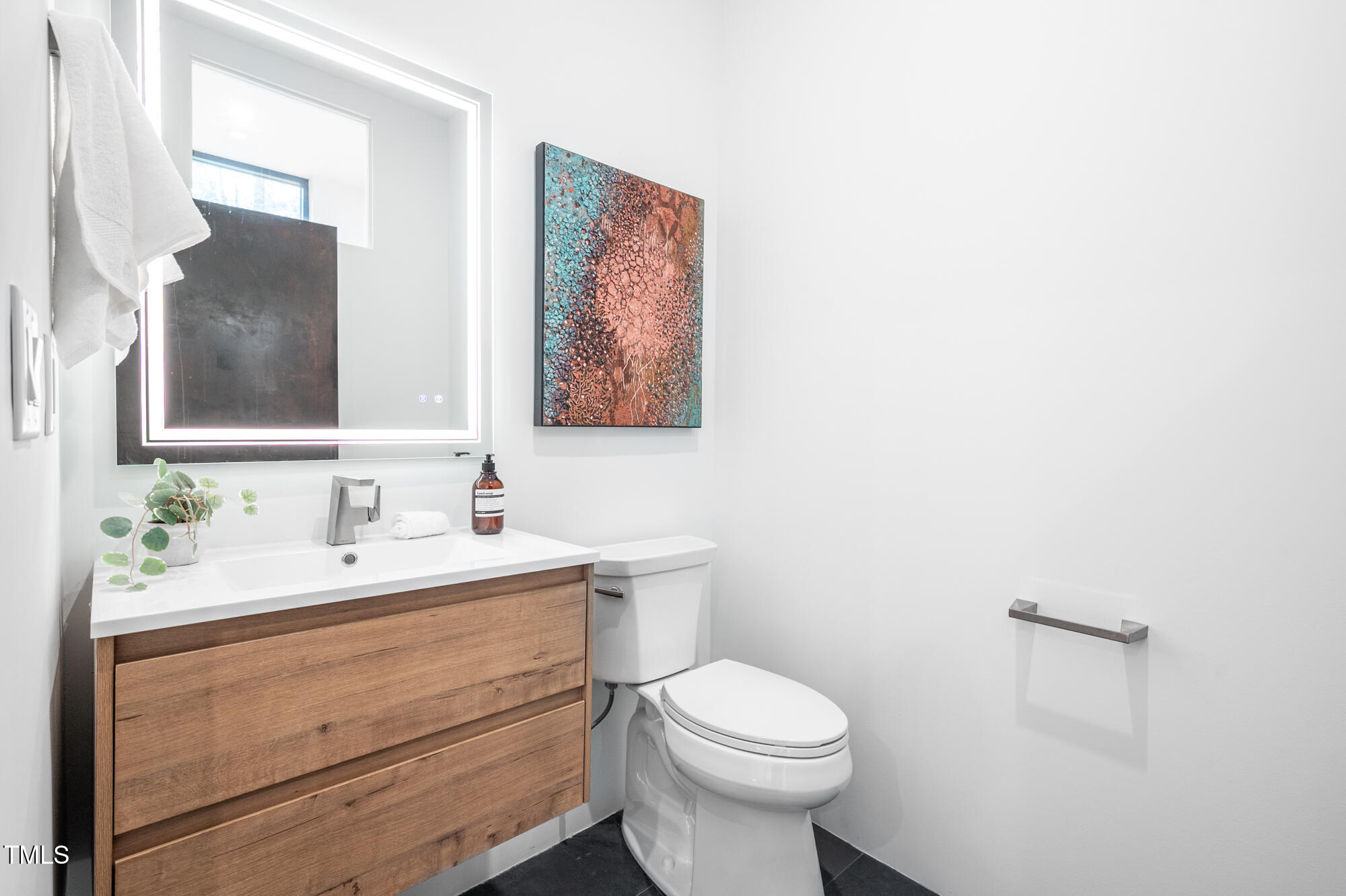 721 Jones Ferry Road Chapel Hill, NC 27516 - Photo 33 of 43 a bathroom with a toilet sink and mirror