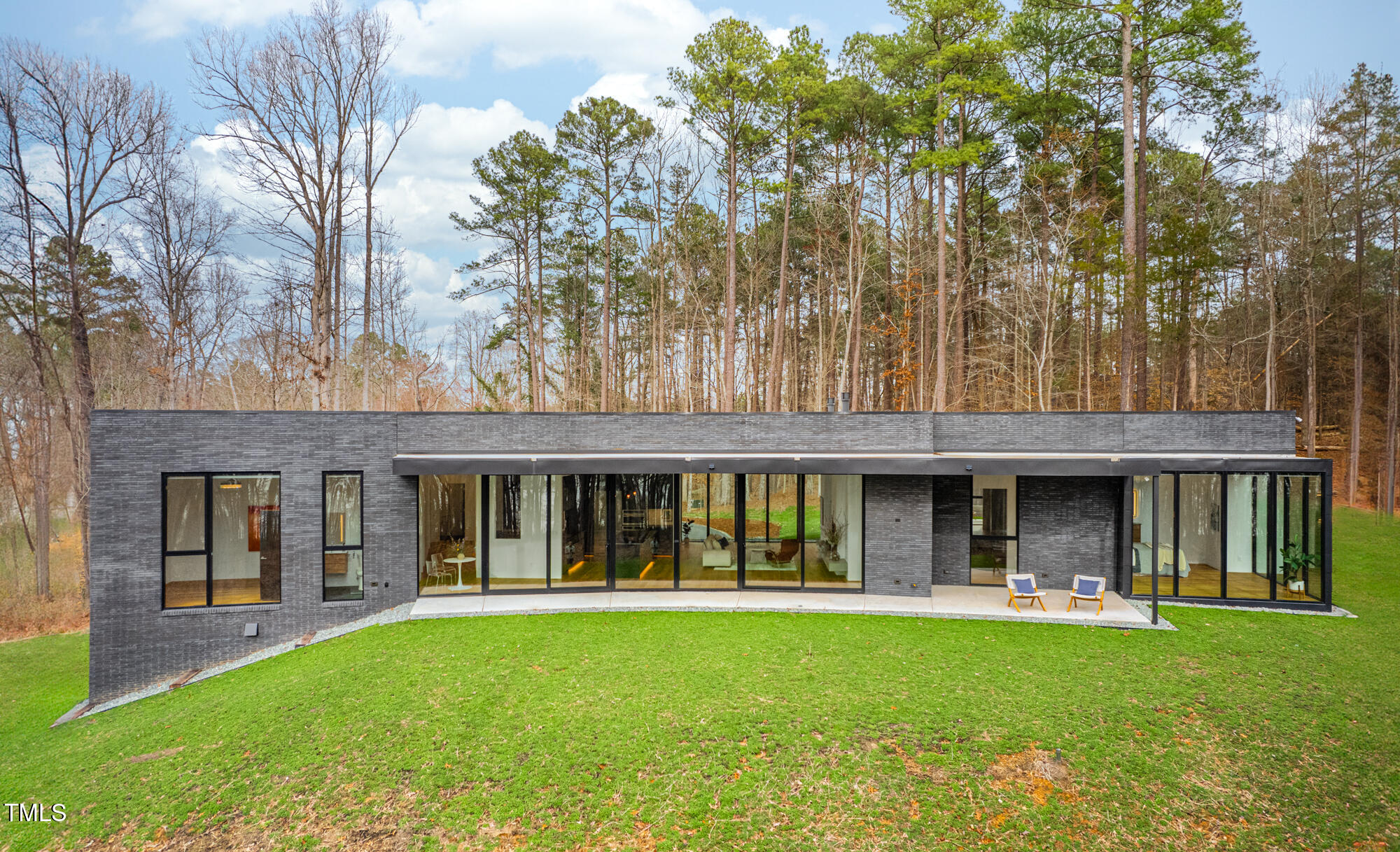 721 Jones Ferry Road Chapel Hill, NC 27516 - Photo 36 of 43 a view of an house with backyard porch and garden