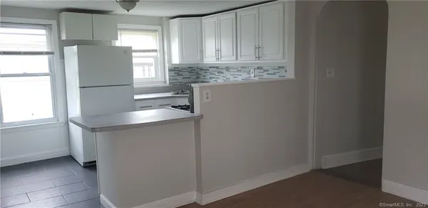 a kitchen with stainless steel appliances granite countertop a sink and a refrigerator