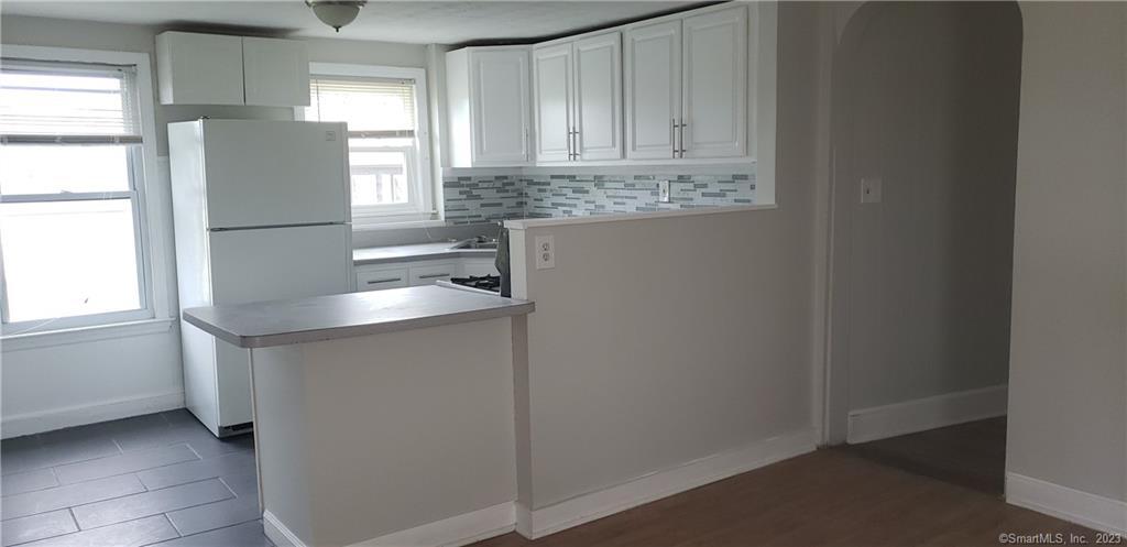 25 South End Road, Unit 2 East Haven, CT 06512 - Photo 1 of 18 a kitchen with stainless steel appliances granite countertop a sink and a refrigerator