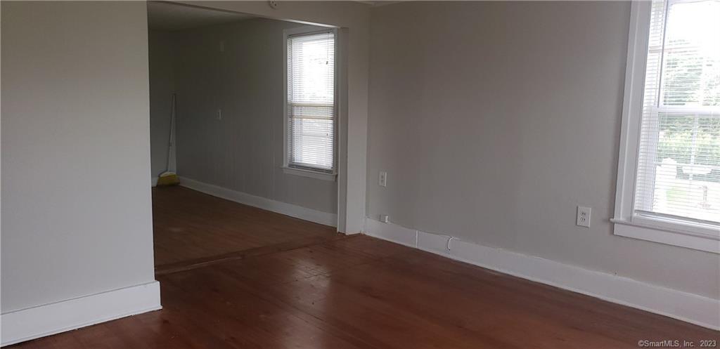 25 South End Road, Unit 2 East Haven, CT 06512 - Photo 2 of 18 an empty room with wooden floor and windows