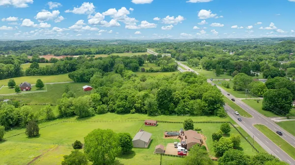 a view of a city with lush green forest