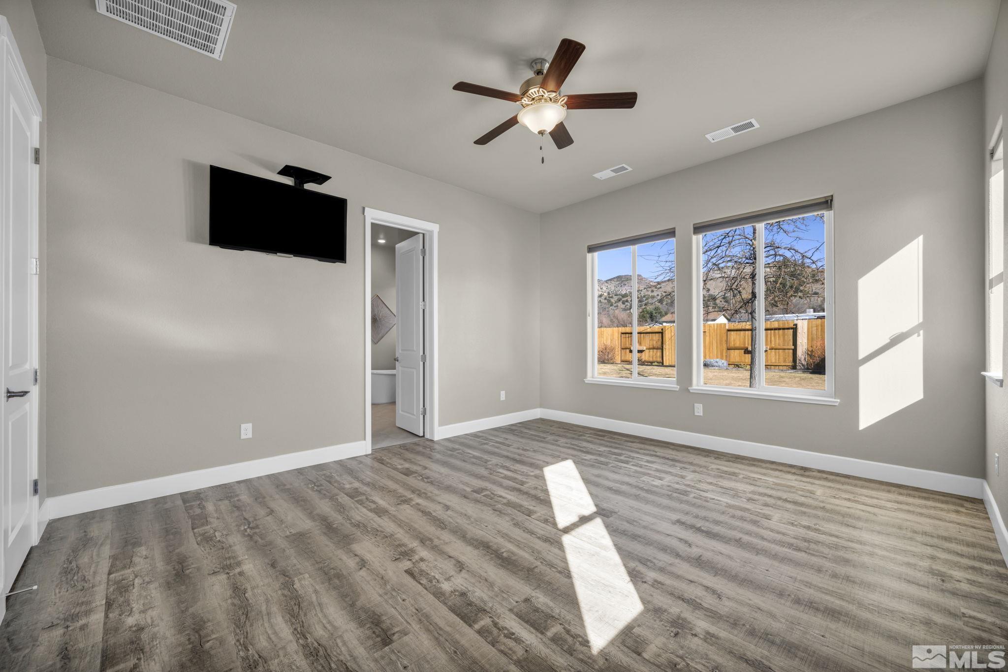 14264 Silver Moon Court Reno, NV 89521 - Photo 16 of 39 a view of empty room with wooden floor and fan