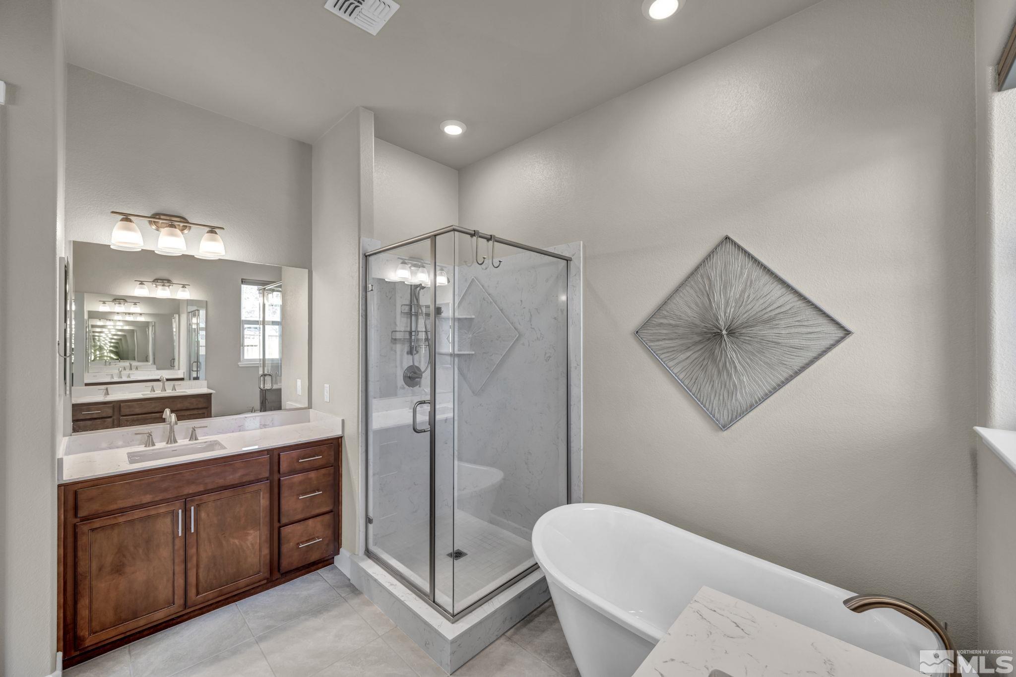 14264 Silver Moon Court Reno, NV 89521 - Photo 17 of 39 a bathroom with a double vanity sink toilet and shower