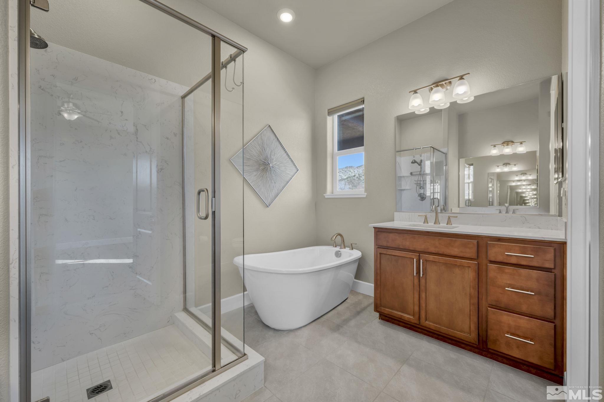 14264 Silver Moon Court Reno, NV 89521 - Photo 18 of 39 a bathroom with a double vanity sink a mirror and a shower
