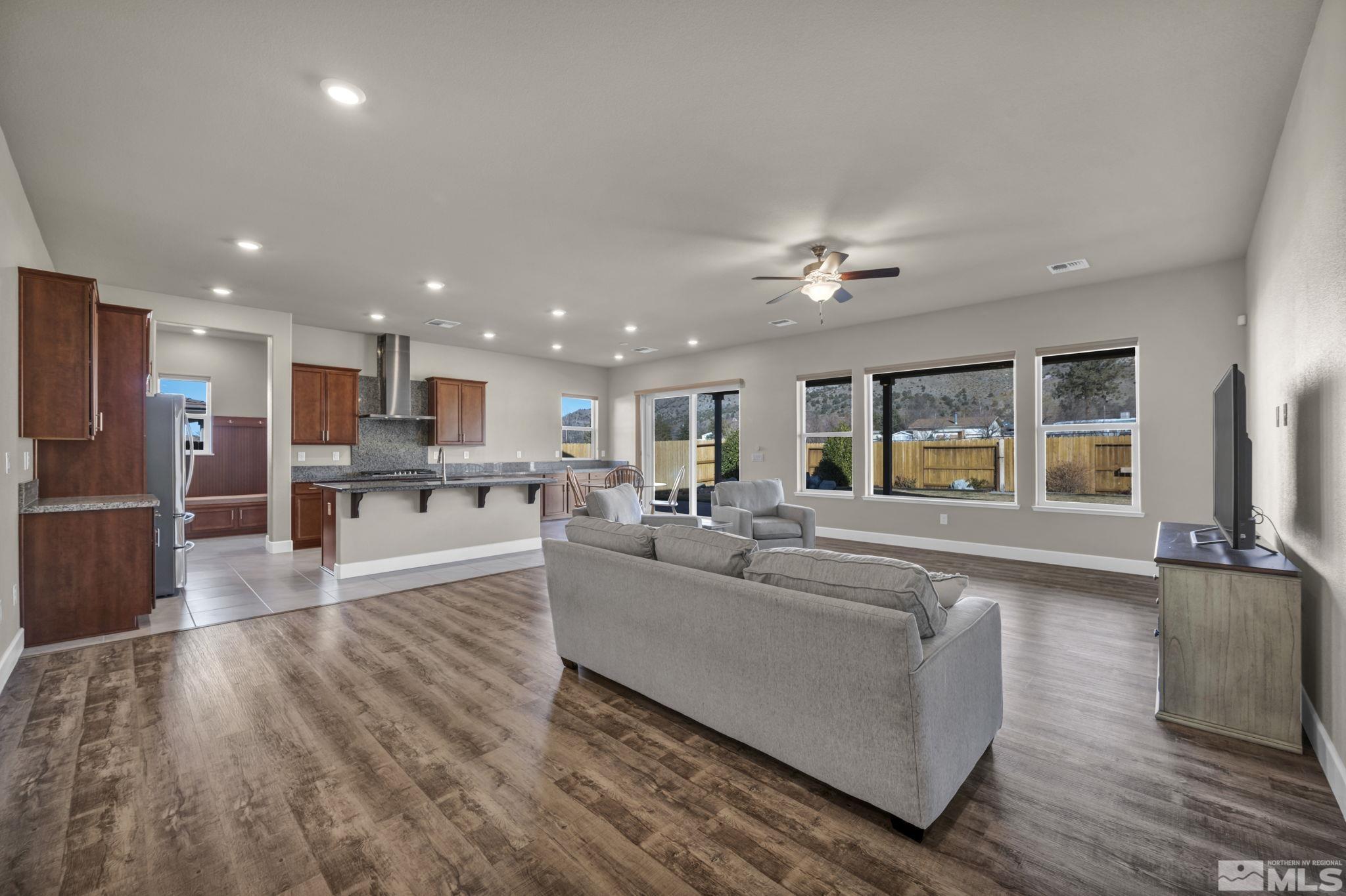 14264 Silver Moon Court Reno, NV 89521 - Photo 4 of 39 a living room with furniture and kitchen view with wooden floor