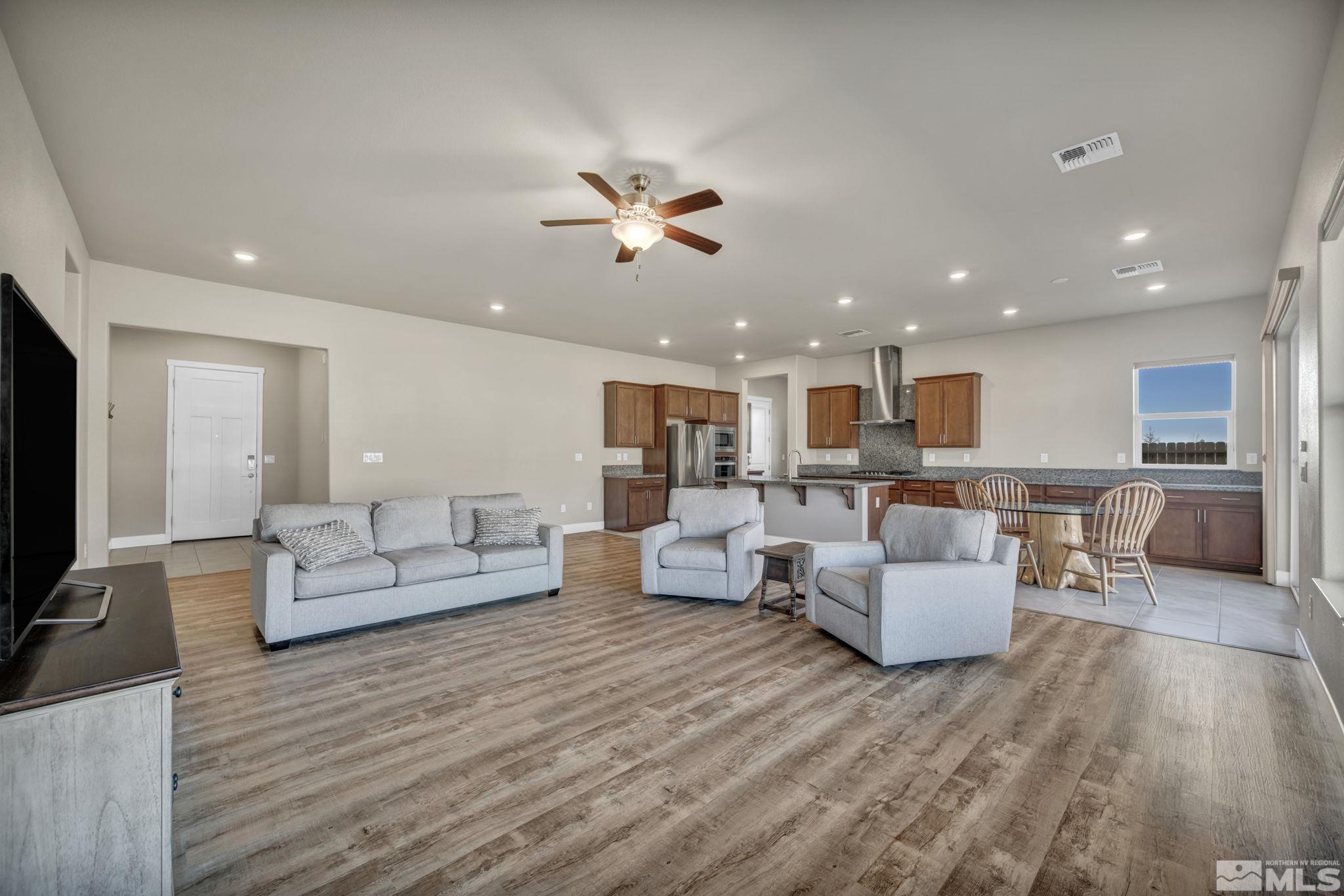 14264 Silver Moon Court Reno, NV 89521 - Photo 7 of 39 a living room with furniture kitchen view and a wooden floor