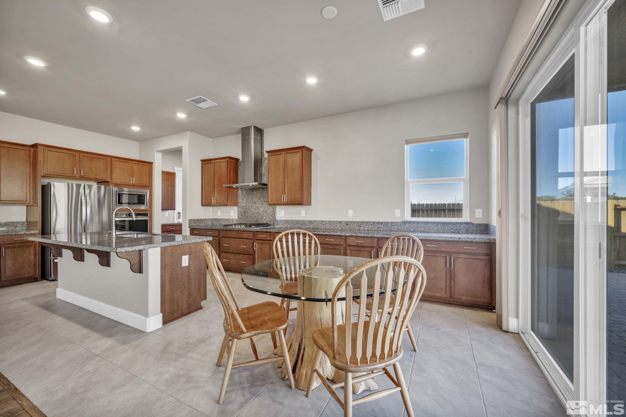 14264 Silver Moon Court Reno, NV 89521 - Photo 8 of 39 a dining room with furniture and window
