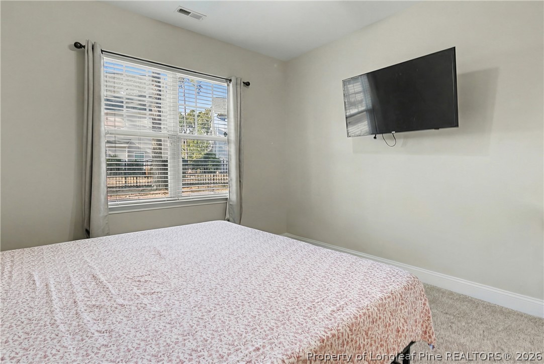 47 Pinnacle Drive Spring Lake, NC 28390 - Photo 19 of 50 a bedroom with a flat screen tv and a window