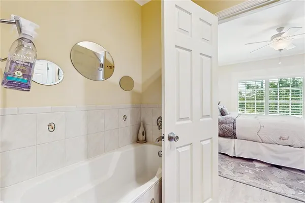 a bathroom with a granite countertop double vanity and a mirror