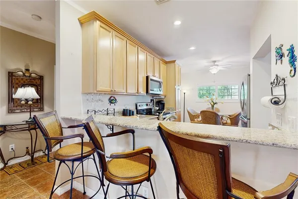 a living room with furniture a table and chairs next to a window