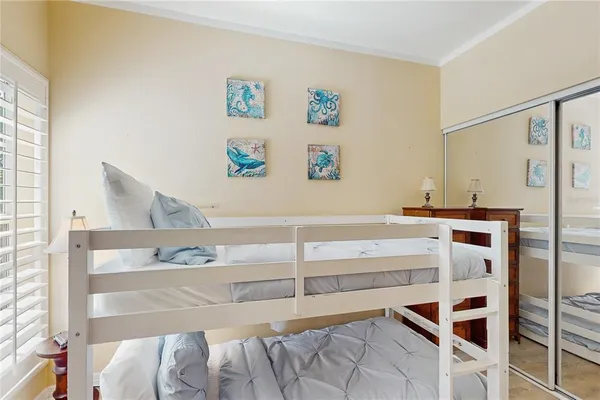 a bedroom with a large bed and a chandelier