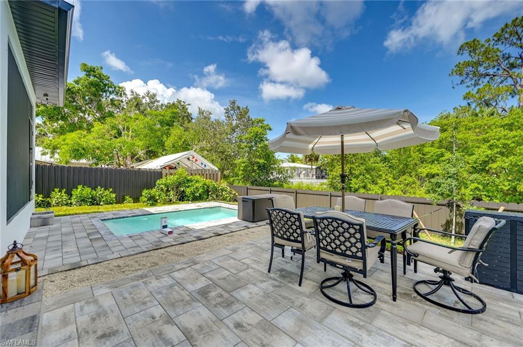 3400 Canal Street Naples, FL 34112 - Photo 18 of 28 Fenced backyard with a patio and outdoor dining space