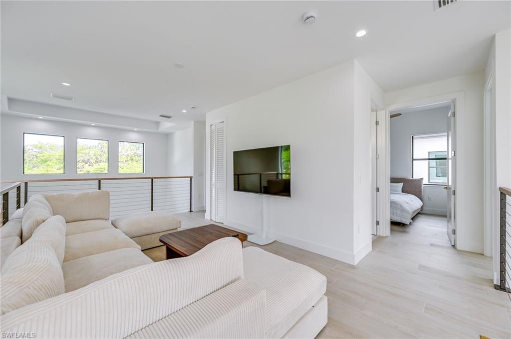 3400 Canal Street Naples, FL 34112 - Photo 21 of 28 Living area featuring recessed lighting, healthy amount of natural light, and light wood-style flooring