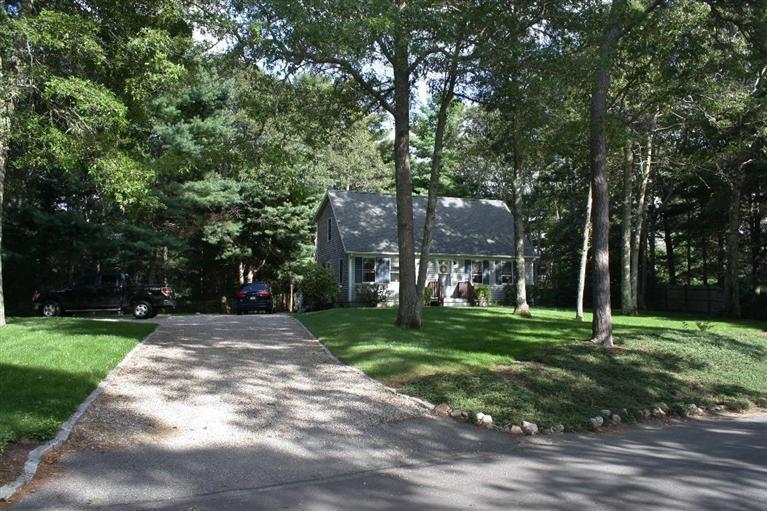 46 Deer Ridge Road Mashpee, MA 02649 - Photo 2 of 33 a view of a big house with a big yard and large trees