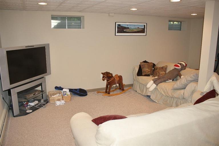46 Deer Ridge Road Mashpee, MA 02649 - Photo 24 of 33 a bedroom with a bed and a flat screen tv