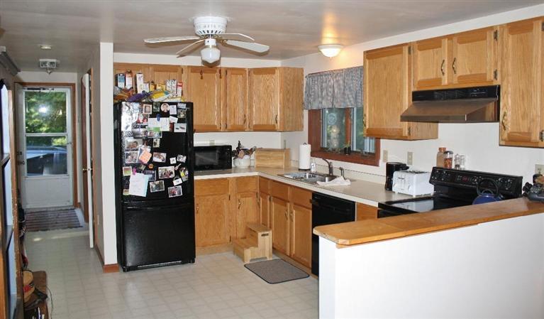 46 Deer Ridge Road Mashpee, MA 02649 - Photo 7 of 33 a kitchen with stainless steel appliances kitchen island granite countertop a refrigerator a stove top oven a sink and dishwasher
