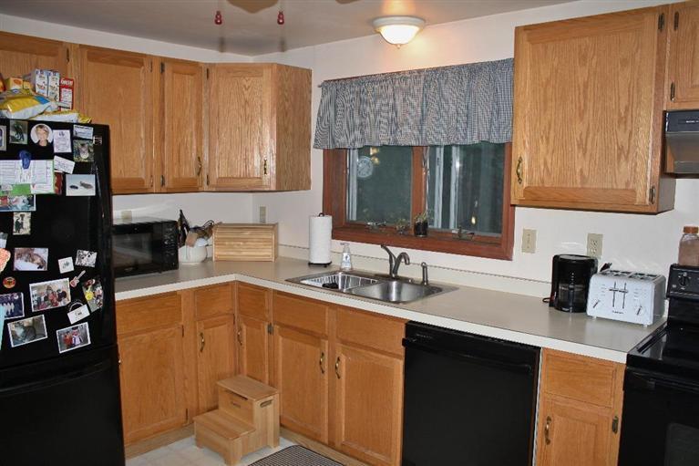 46 Deer Ridge Road Mashpee, MA 02649 - Photo 8 of 33 a kitchen with a sink stove and cabinets