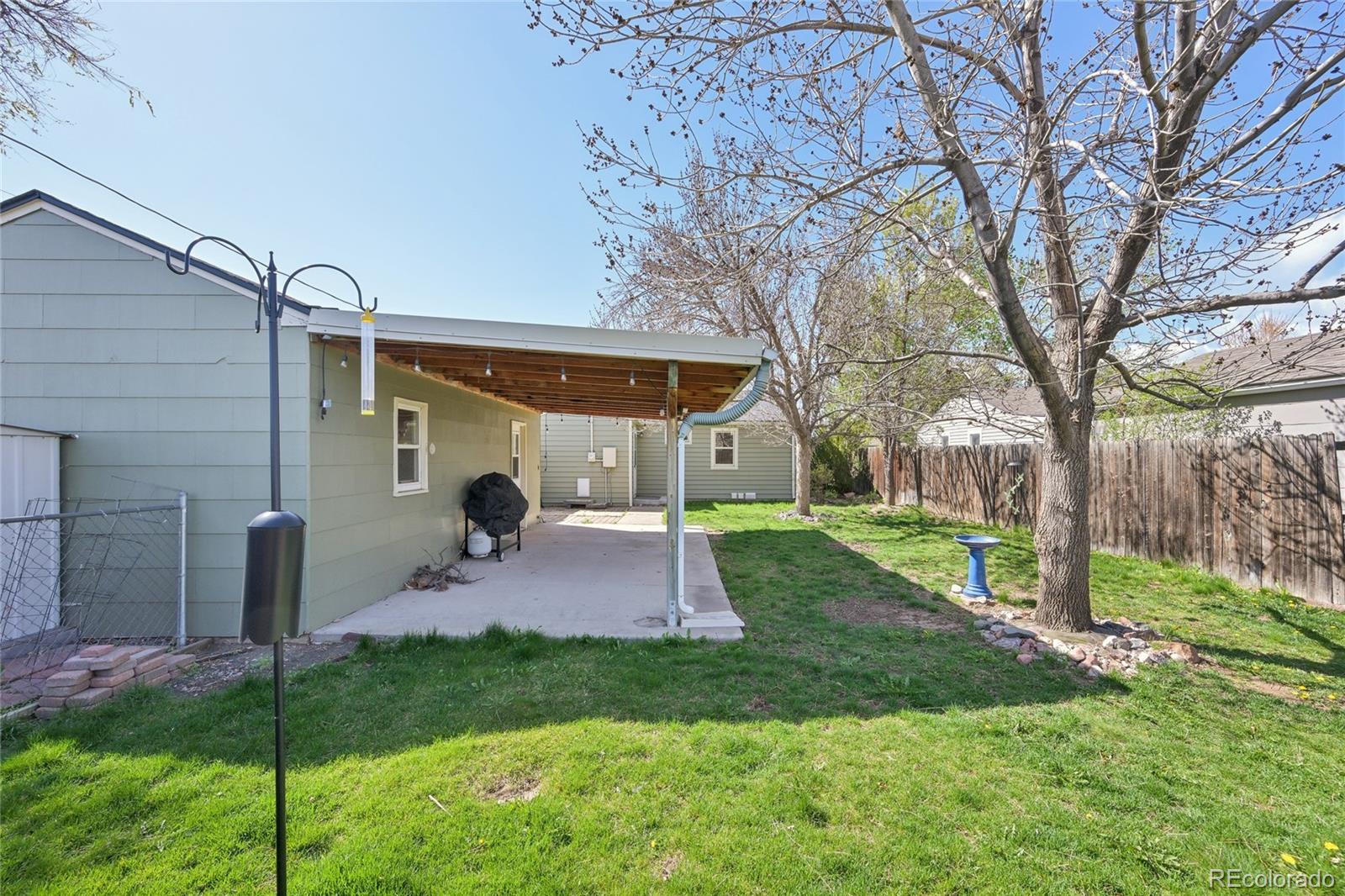 6819 Reno Drive Arvada, CO 80002 - Photo 29 of 32 a backyard of a house with table and chairs