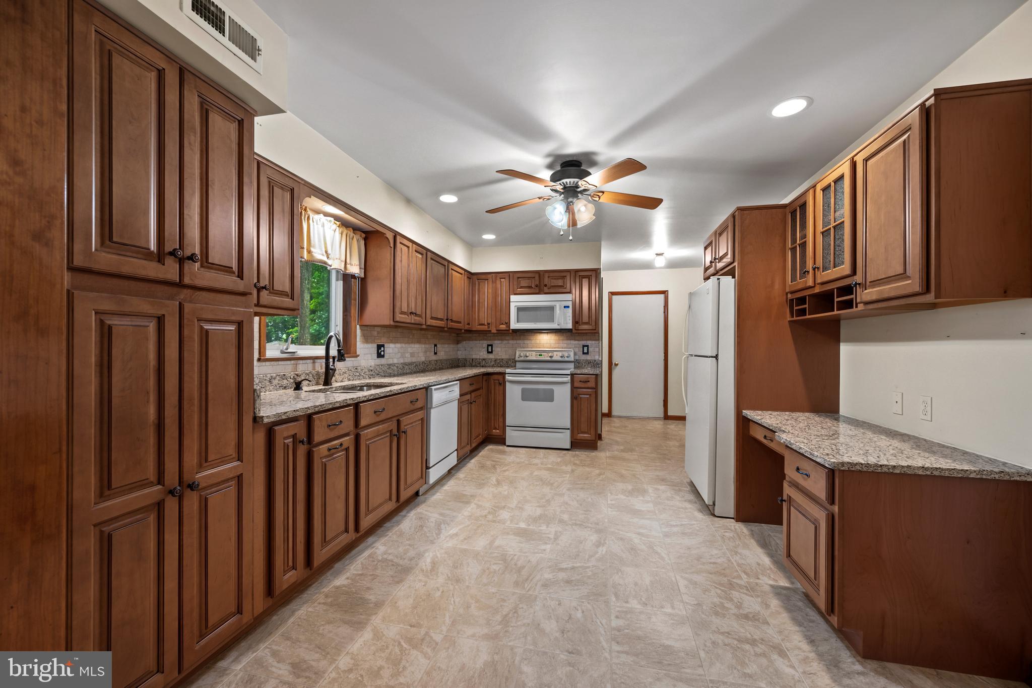 5313 Wentz Road Manchester, MD 21102 - Photo 35 of 51 a kitchen with stainless steel appliances granite countertop a refrigerator a stove and a sink