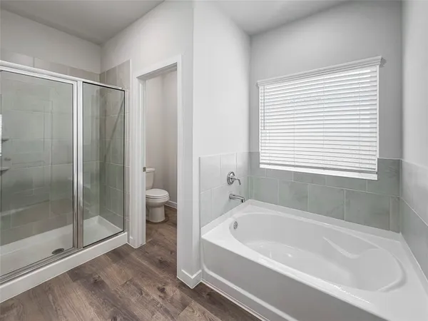 a bathroom with a bathtub and a shower