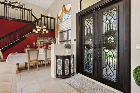 a living room with furniture and a large window with kitchen view