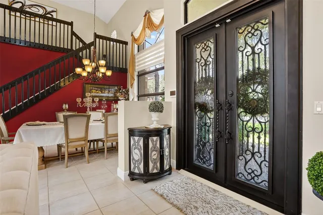 a living room with furniture and a large window with kitchen view
