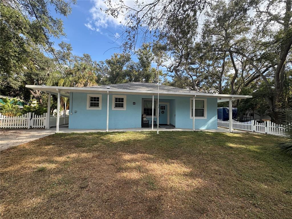 3715 Valley Tree Drive Tampa, FL 33610 - Photo 1 of 26 a front view of a house with a garden
