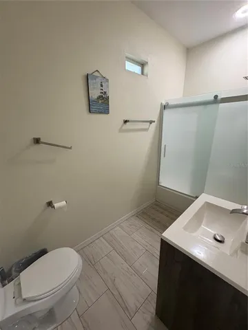 a bathroom with a sink a toilet and vanity