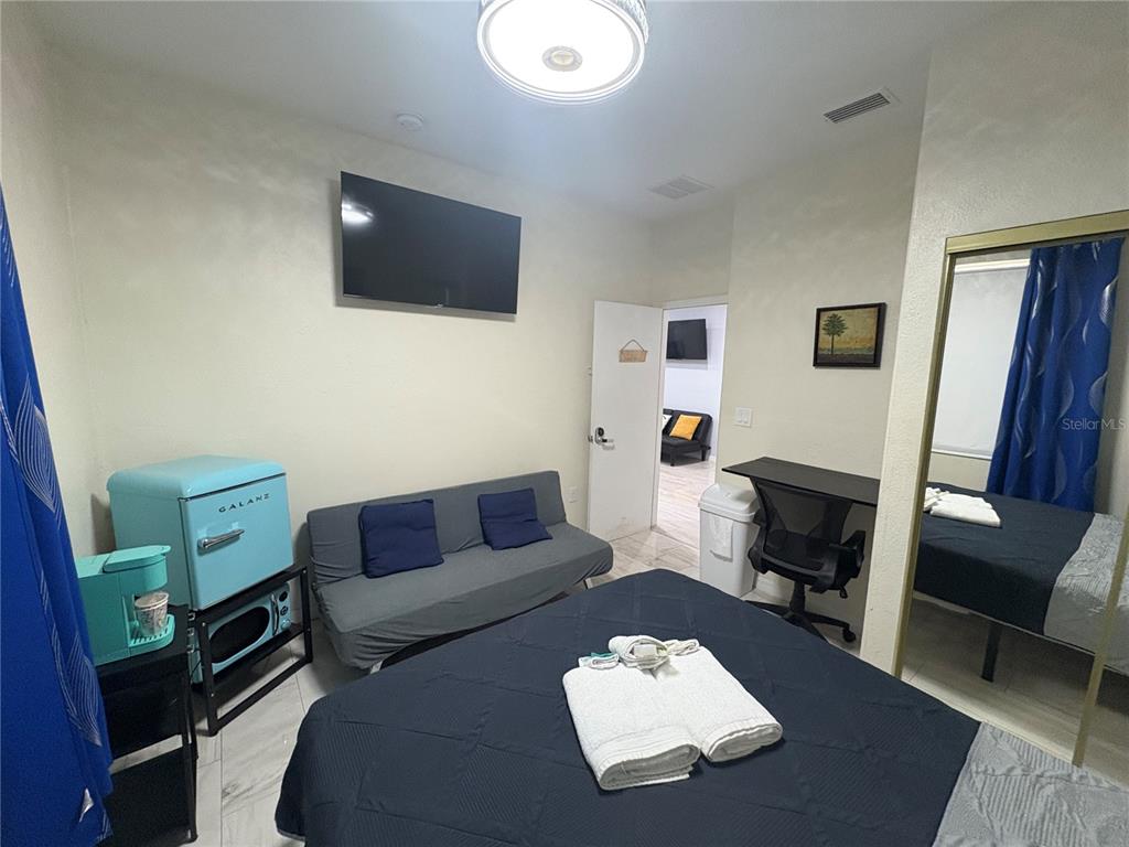 3715 Valley Tree Drive Tampa, FL 33610 - Photo 13 of 26 a living room with furniture and a flat screen tv