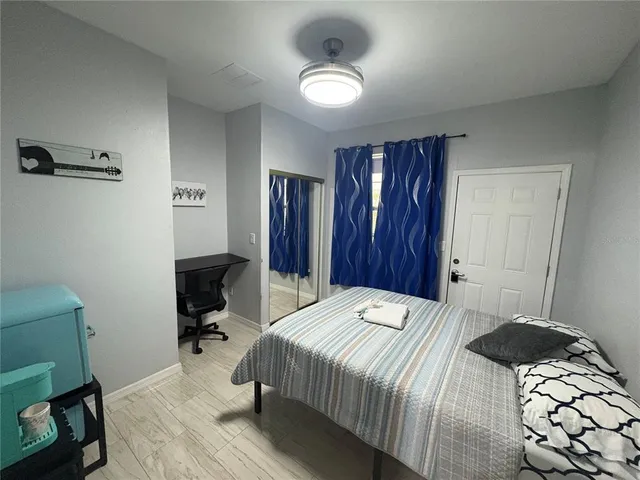 a bedroom with a bed and a chair