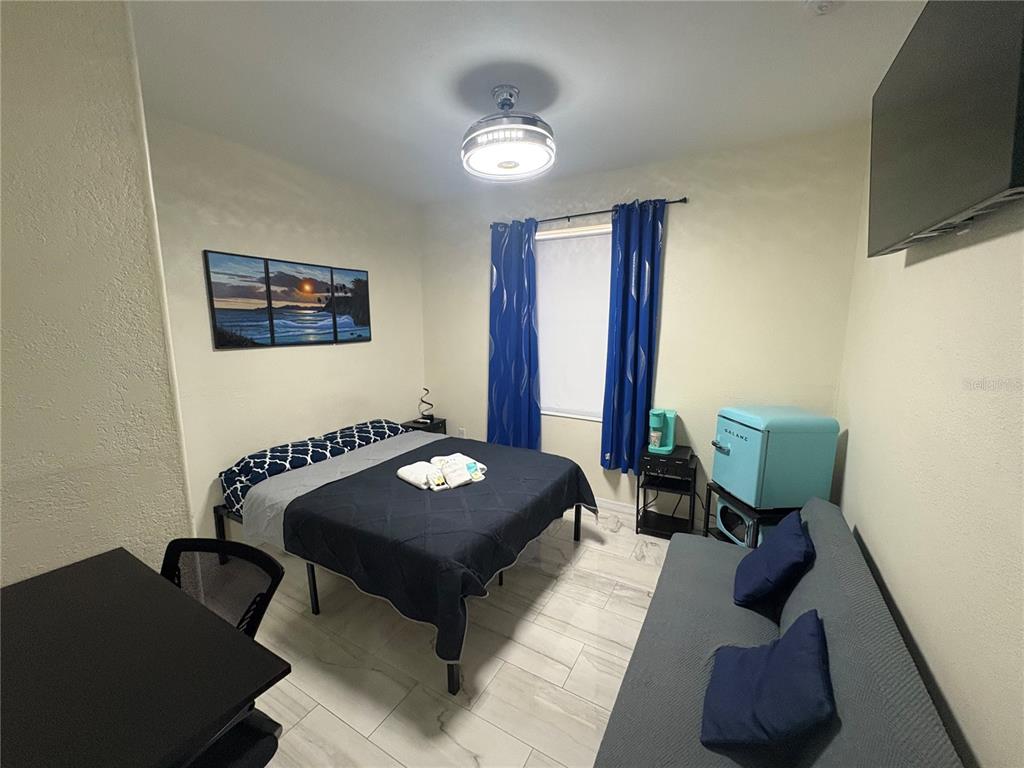 3715 Valley Tree Drive Tampa, FL 33610 - Photo 21 of 26 a living room with furniture and a flat screen tv