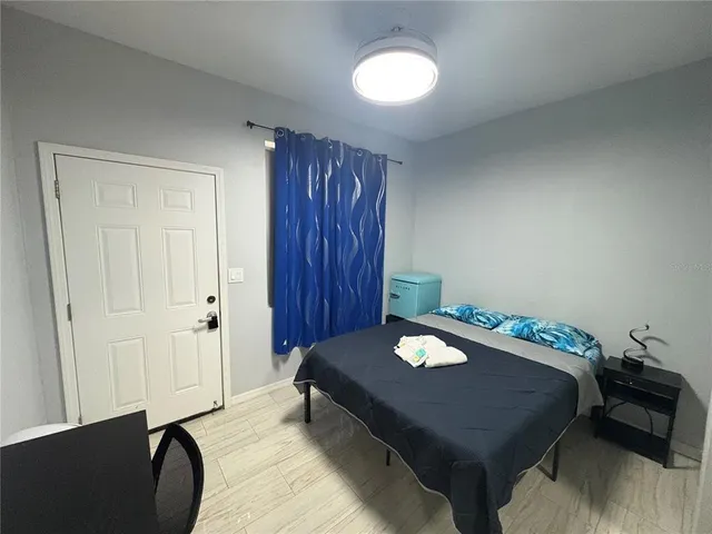 a bedroom with a bed and a lamp