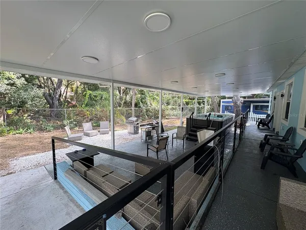 a room with lots of wooden furniture and glass windows