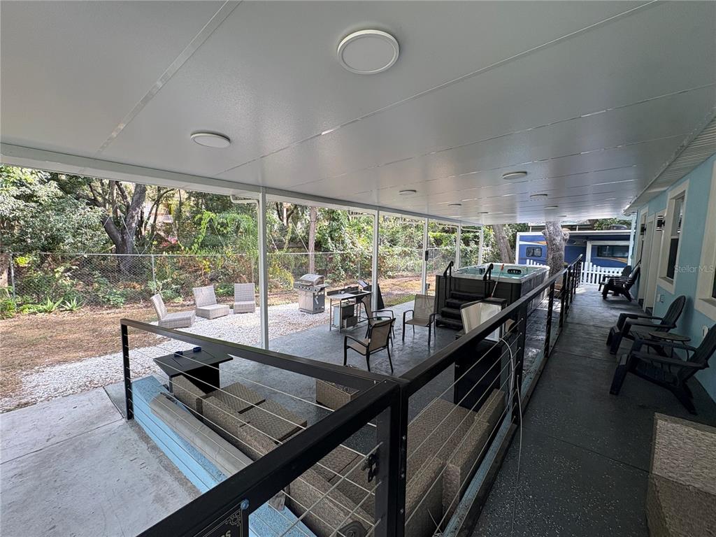 3715 Valley Tree Drive Tampa, FL 33610 - Photo 24 of 26 a room with lots of wooden furniture and glass windows