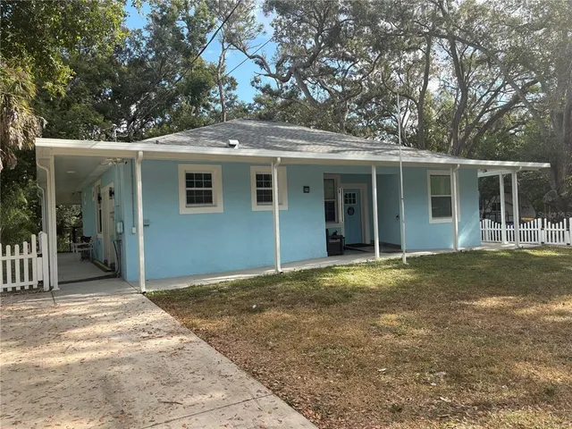 a view of a house with a backyard and balcony