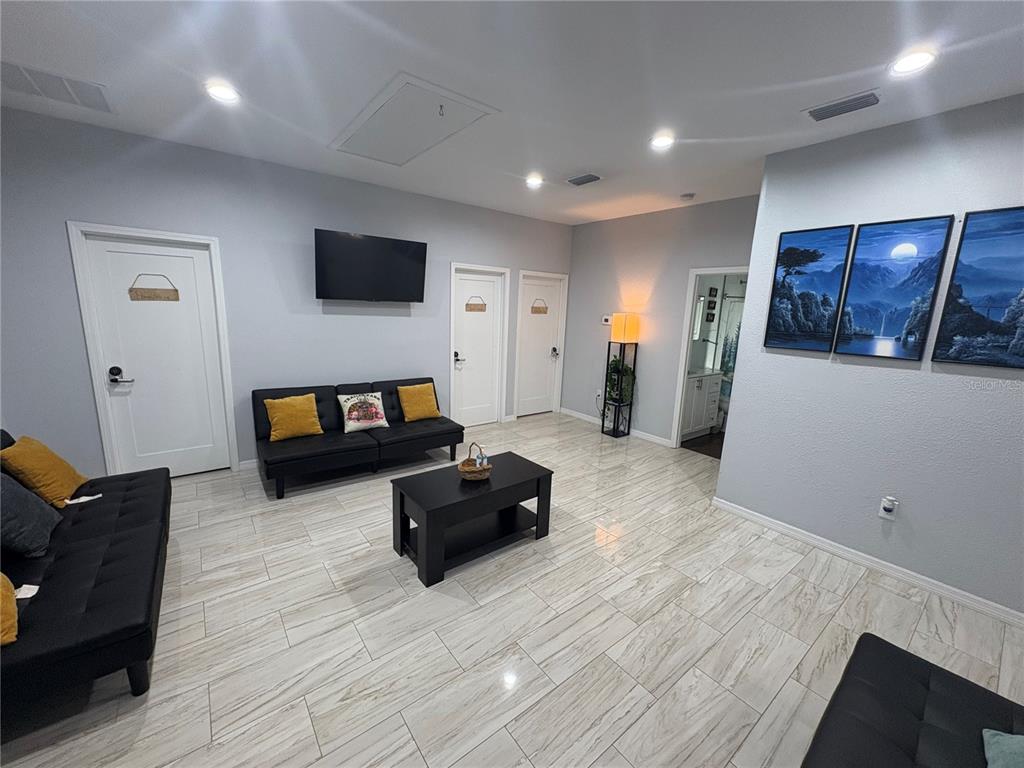 3715 Valley Tree Drive Tampa, FL 33610 - Photo 6 of 26 a living room with furniture and a flat screen tv