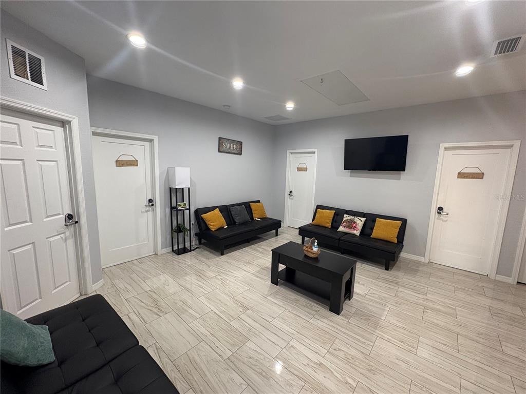 3715 Valley Tree Drive Tampa, FL 33610 - Photo 7 of 26 a living room with furniture and a flat screen tv