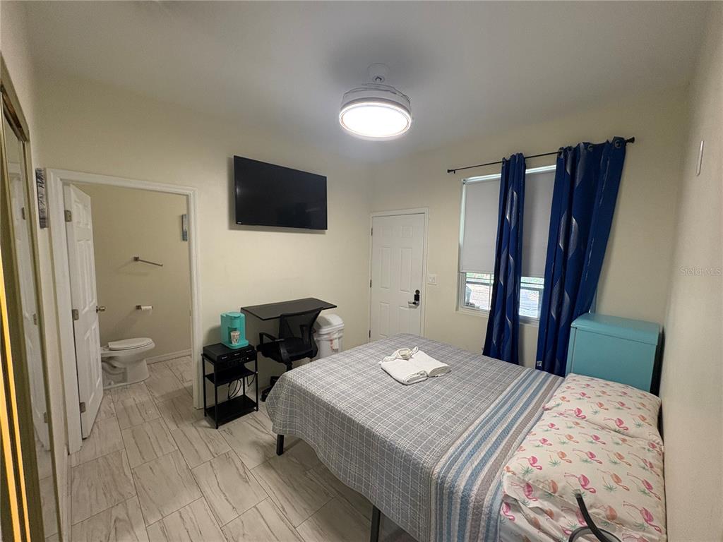 3715 Valley Tree Drive Tampa, FL 33610 - Photo 10 of 26 a bedroom with a bed and a television