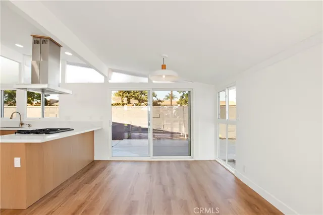 a view of a kitchen cabinets a stove and wooden floor
