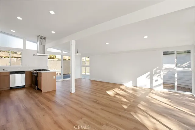 a kitchen with stainless steel appliances kitchen island granite countertop a stove a sink and a refrigerator