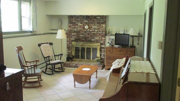 9 Highland Road Merrimac, MA 01860 - Photo 18 of 20 a living room with furniture a flat screen tv and a fireplace