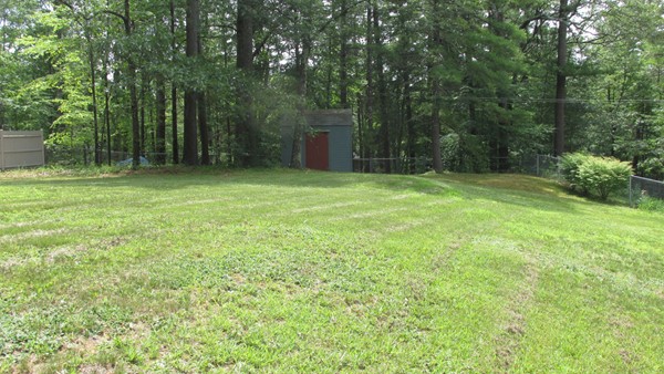 9 Highland Road Merrimac, MA 01860 - Photo 7 of 20 a yard with trees in the background