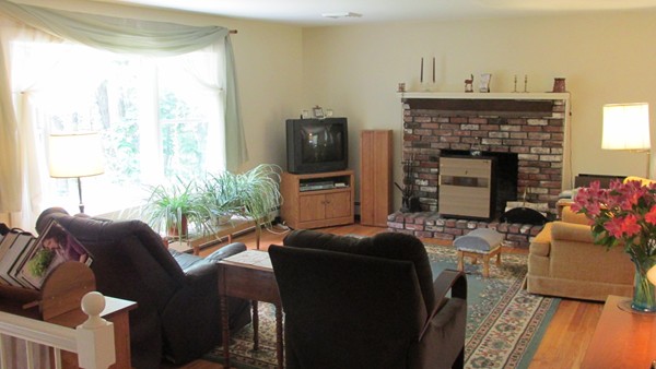 9 Highland Road Merrimac, MA 01860 - Photo 10 of 20 a living room with furniture a fireplace and a flat screen tv