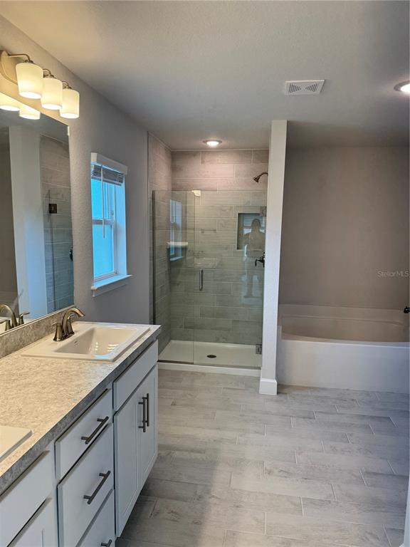 1157 Duquesne Road Venice, FL 34293 - Photo 12 of 15 a spacious bathroom with a granite countertop sink a toilet a mirror and shower