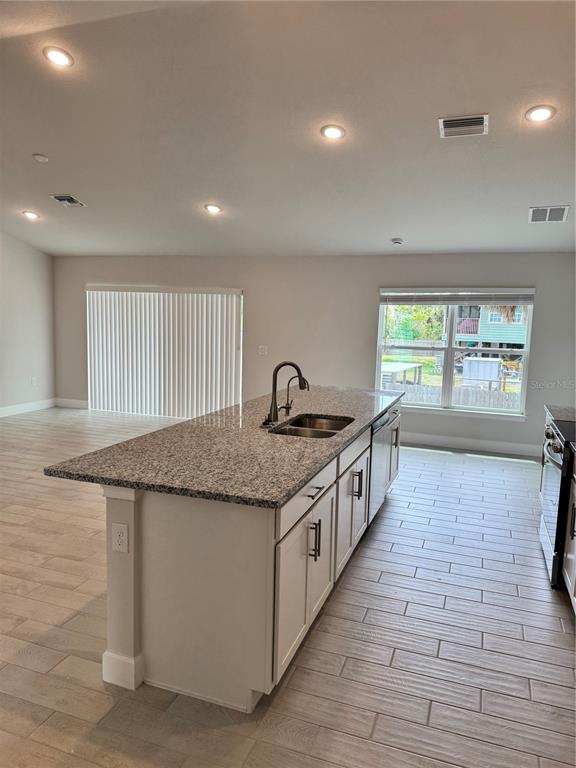 1157 Duquesne Road Venice, FL 34293 - Photo 10 of 15 a kitchen with granite countertop a stove and a sink