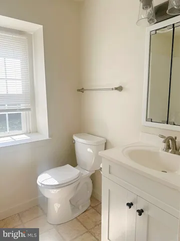 a white toilet sitting next to a bathroom sink
