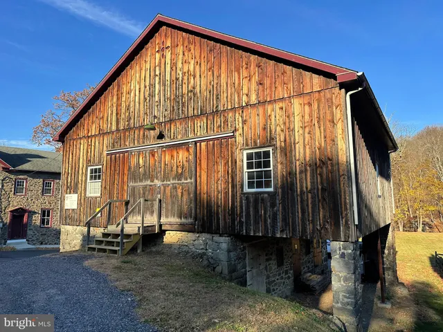 a view of an house with backyard and sitting area