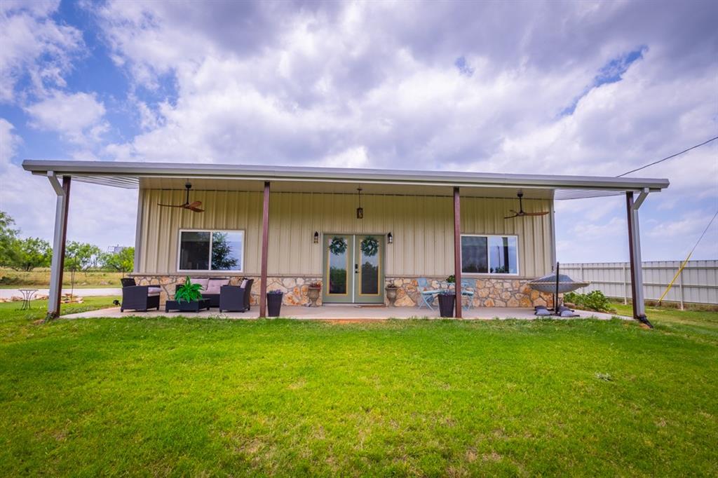 7060 Hells Gate Loop Strawn, TX 76475 - Photo 24 of 40 a front view of house with yard and outdoor seating