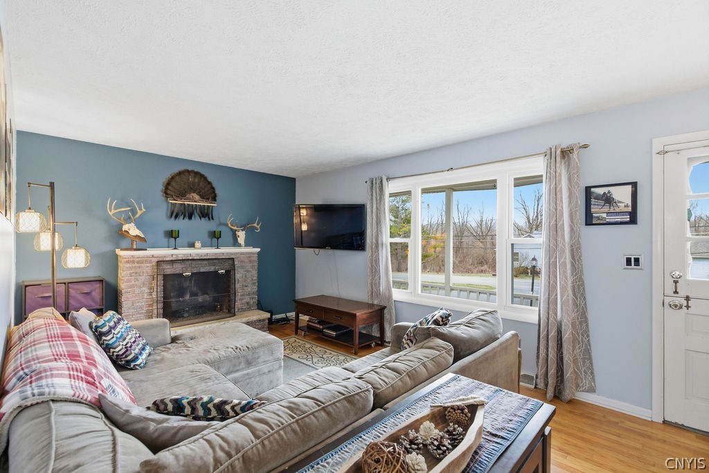 7017 Bolivar Road Sullivan, NY 13037 - Photo 11 of 40 The living room features a gas fireplace and the p